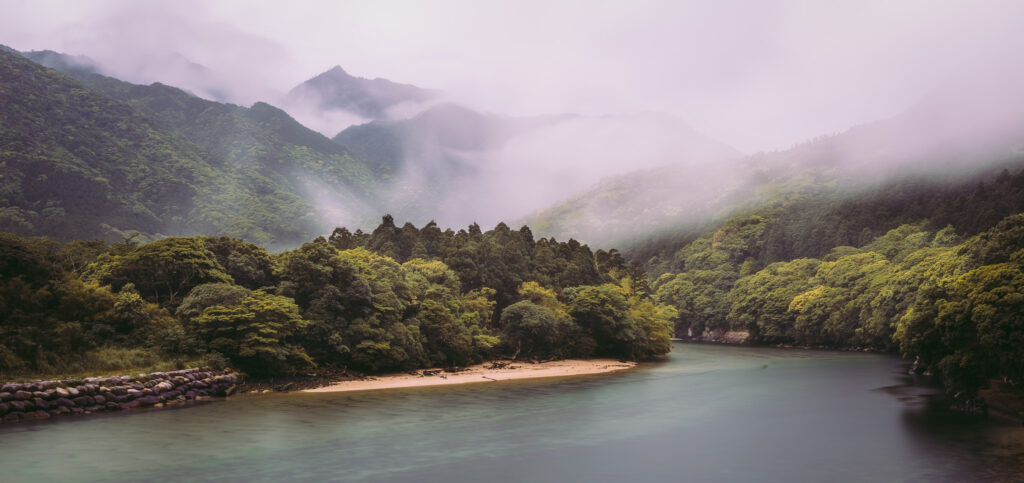 yakushima-miyanoura-river-mist-mountain-fores Mist-covered mountains and lush forest lining the Miyanoura River in Yakushima, Japan