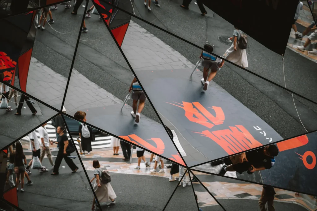 A chaotic city scene fractured by reflective glass panels, showing scattered movement