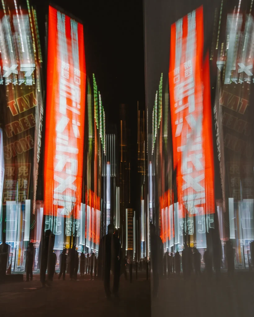 Abstract mirrored blurred image of neon signs and people in Tokyo street