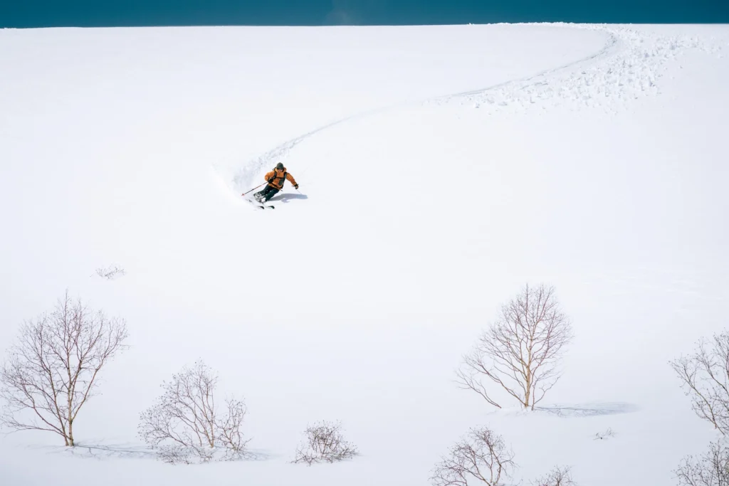 Ski photography example with skier on bright snow, showing how slight exposure compensation keeps the snow white and balanced.