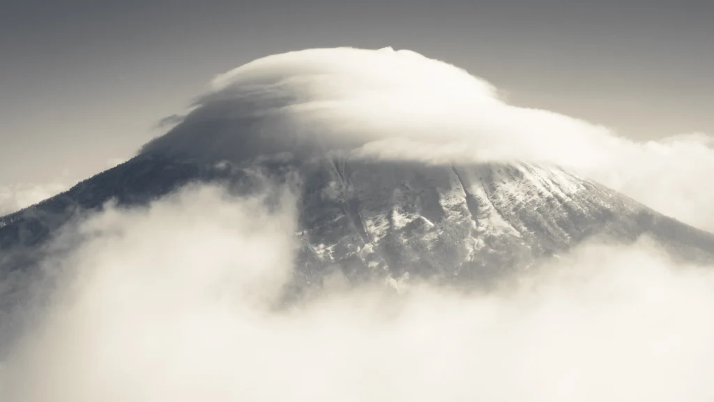 Mount Yotei partially obscured by winter cloud and mist in Hokkaido, Japan.