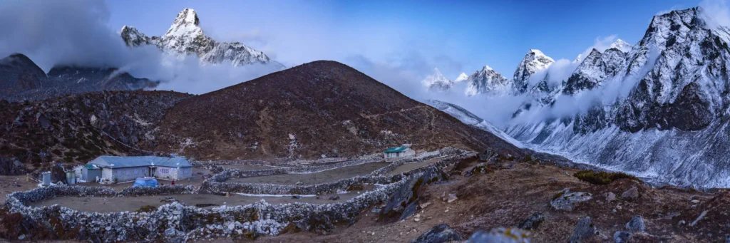 Panoramic mountain landscape of Ama Dablam and a trekking lodge in the Nepal Himalaya