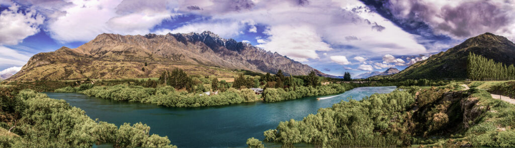 Panoramic landscape of the Kawarau River with the Remarkables mountain range near Queenstown, New Zealand