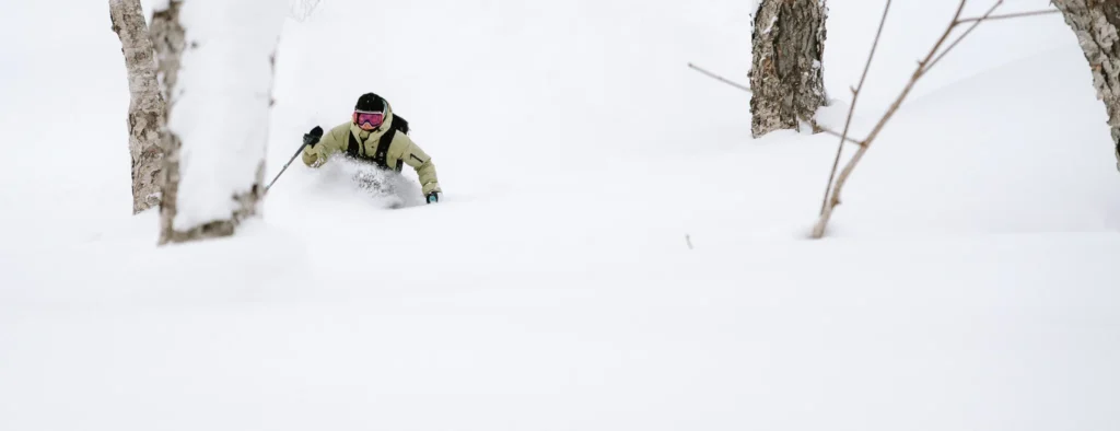 Skier skiing through trees in deep powder using Nikon Z8 autofocus settings
