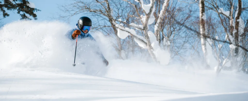 Skier carving through deep powder snow captured using Nikon Z8 ski photography settings